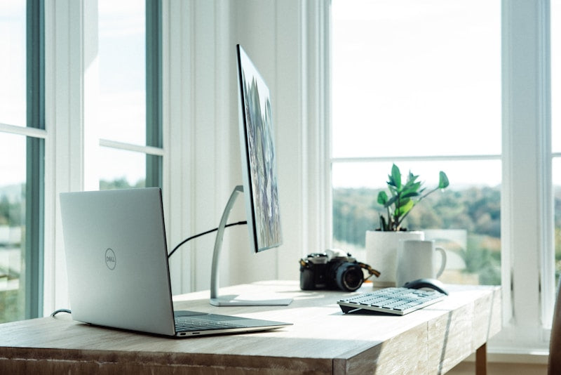 Adjustable aluminum phone and tablet stand on clean home office desk setup