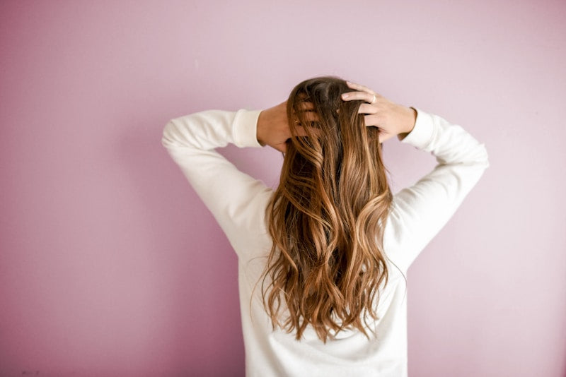 Woman using professional ionic hair dryer with diffuser attachment salon results