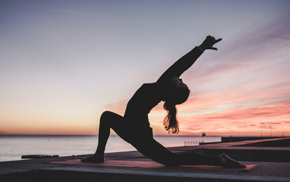Woman in morning yoga practice on non-slip exercise mat at home