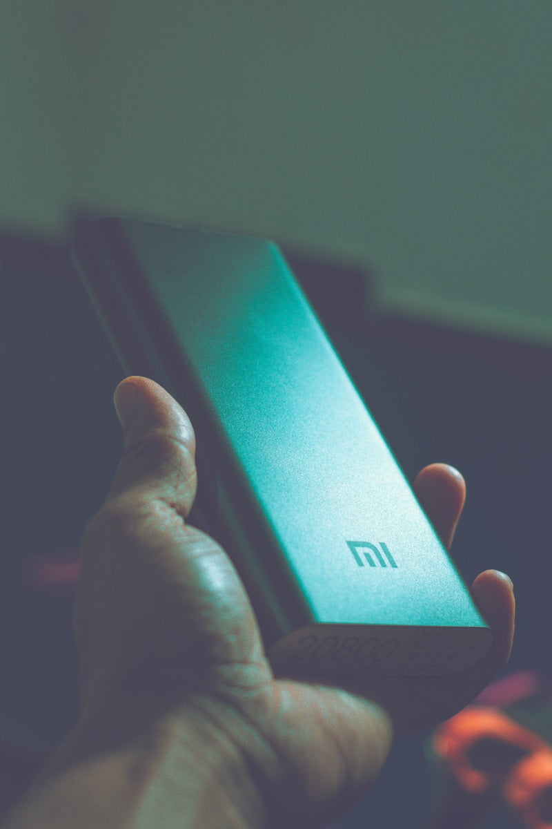 Slim portable power bank charging phone and earbuds on the go travel