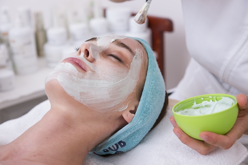 Woman using electric facial cleansing brush for deep pore skincare routine